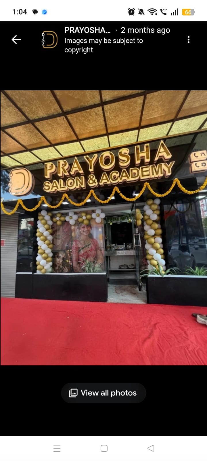 Prayosha Salon & Academy salon exterior with illuminated signage