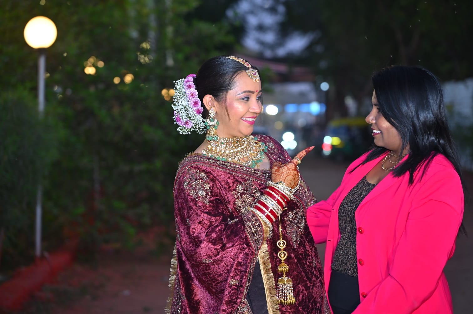 Founder of Prayosha Salon & Academy with a bride in a velvet lehenga at an evening function